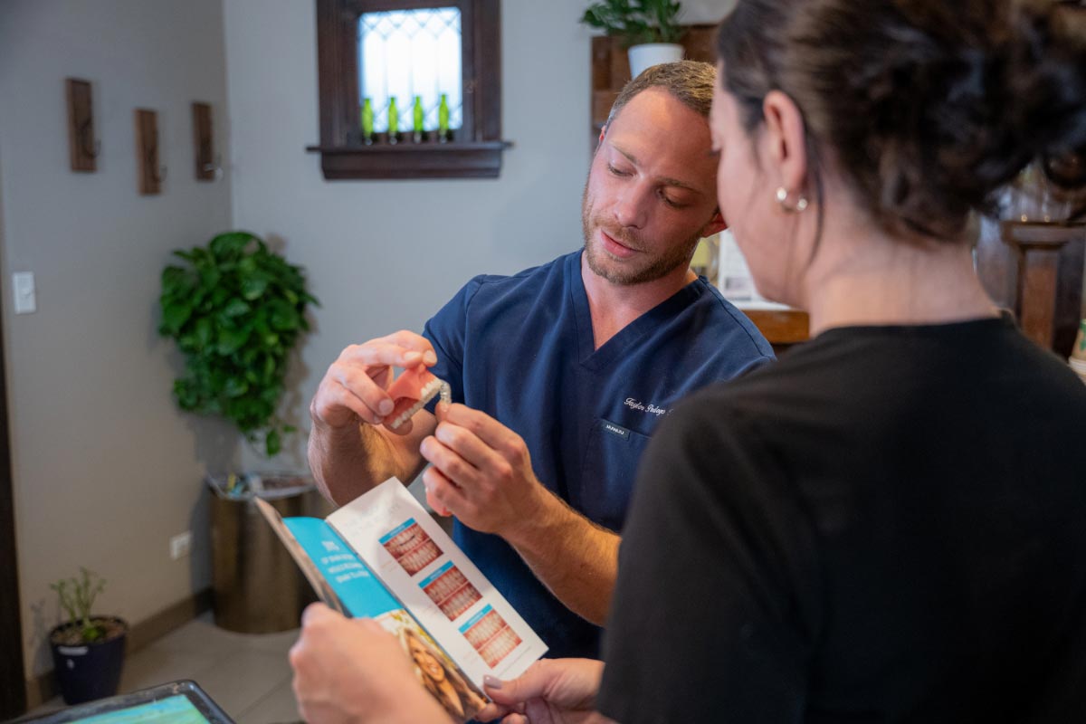 Dr. Pedego showing patient how clear aligners work